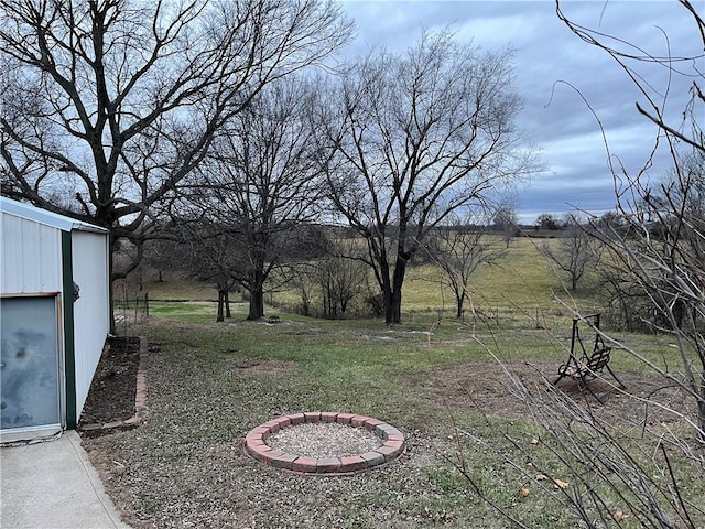 view of yard with an outdoor fire pit