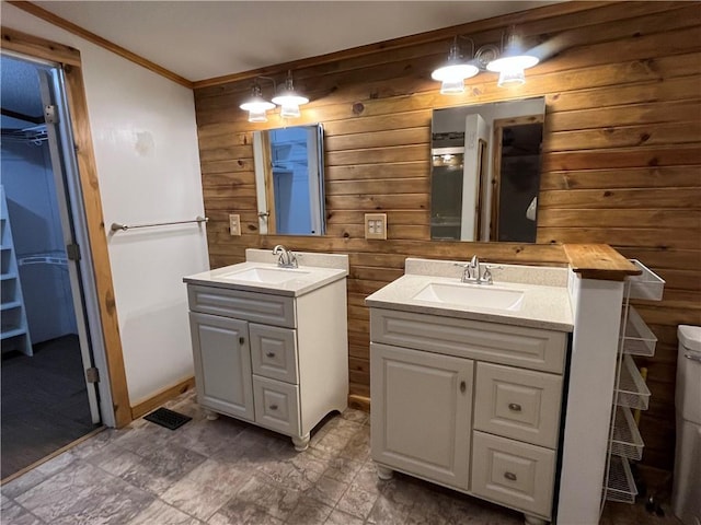 bathroom featuring vanity and wooden walls