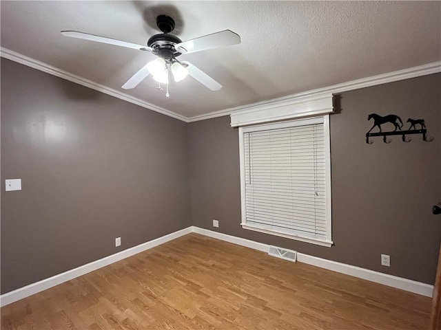 spare room with hardwood / wood-style flooring, ceiling fan, crown molding, and a textured ceiling