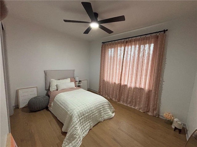 bedroom with ceiling fan and hardwood / wood-style flooring