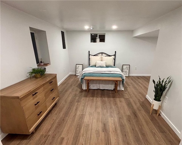 bedroom with dark hardwood / wood-style floors