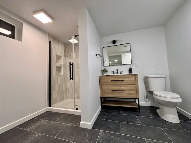 bathroom featuring vanity, toilet, and an enclosed shower