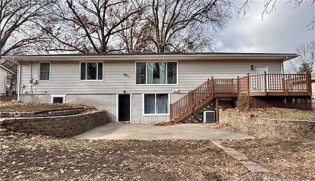 back of house with central AC, a deck, and a patio area