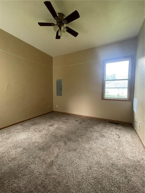 unfurnished room with carpet, ceiling fan, and electric panel