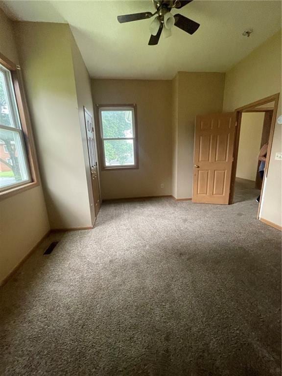 empty room with carpet and ceiling fan