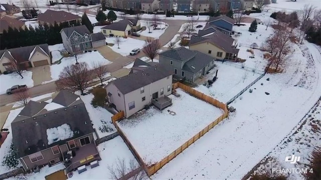 snowy aerial view with a residential view