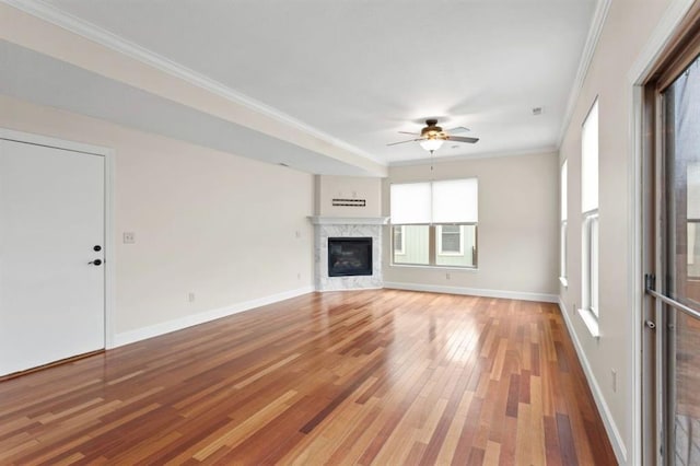 unfurnished living room featuring ceiling fan, ornamental molding, and hardwood / wood-style floors