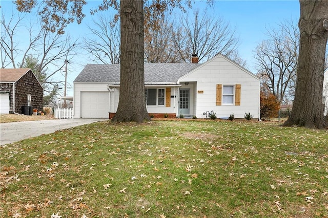 single story home with a front yard and a garage