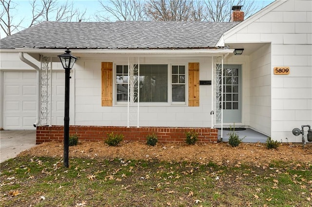 view of exterior entry with a garage