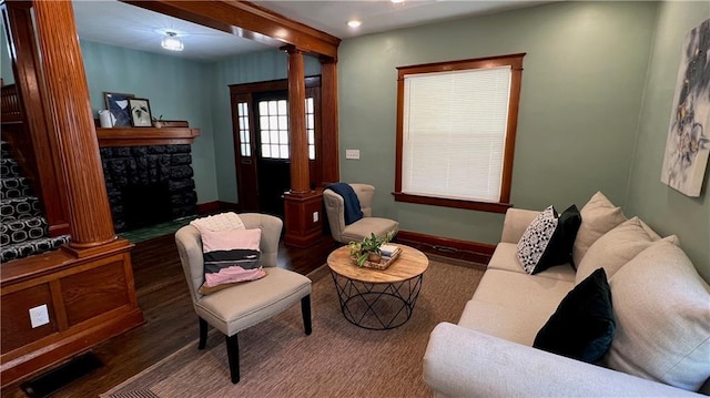 sitting room featuring dark hardwood / wood-style floors and ornate columns