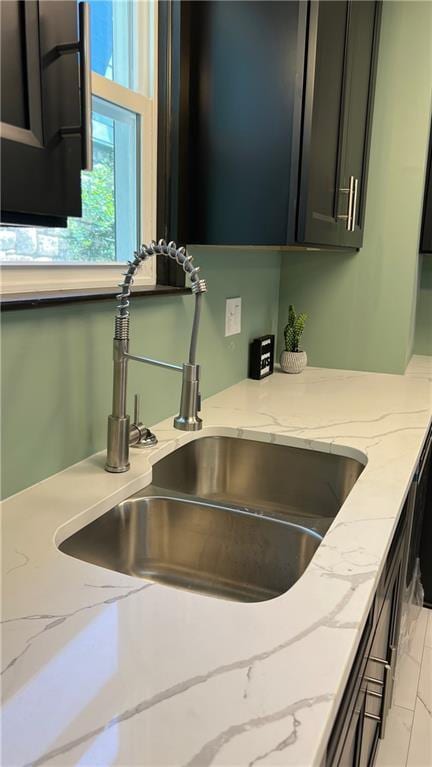 details featuring light stone counters and sink