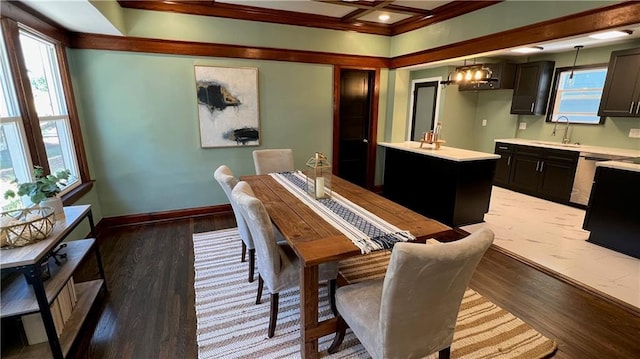 dining room with a notable chandelier, light hardwood / wood-style floors, sink, and beam ceiling