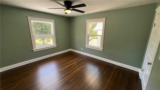 spare room featuring ceiling fan and dark hardwood / wood-style floors