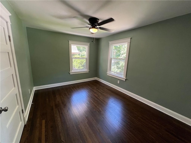 spare room with ceiling fan and dark wood-type flooring