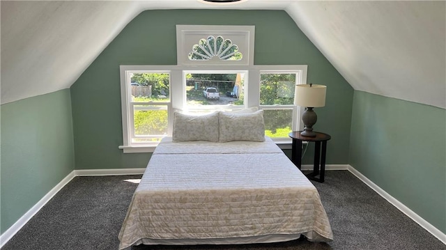 bedroom featuring vaulted ceiling and dark colored carpet