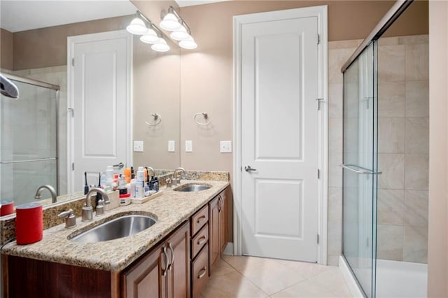 bathroom with tile patterned flooring, vanity, and walk in shower