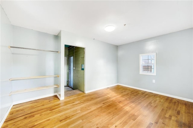 unfurnished bedroom with wood-type flooring and a closet