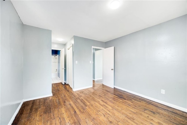 empty room with hardwood / wood-style floors