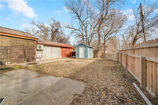 view of yard featuring a storage shed and a patio