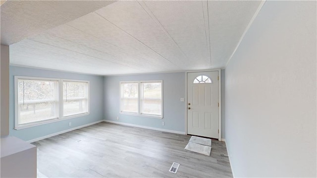 foyer with a textured ceiling and hardwood / wood-style flooring