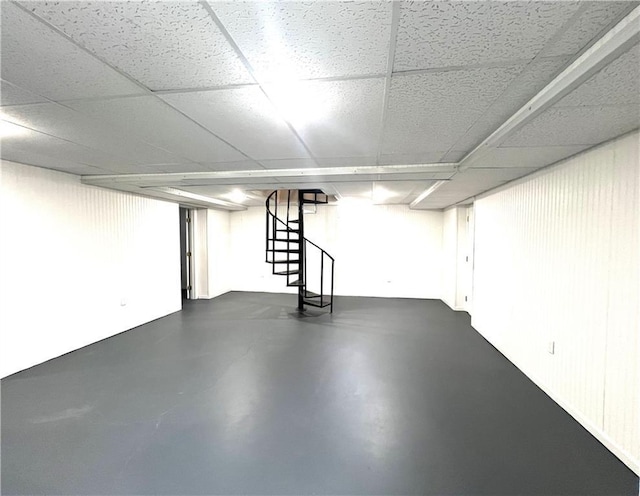 basement with a paneled ceiling