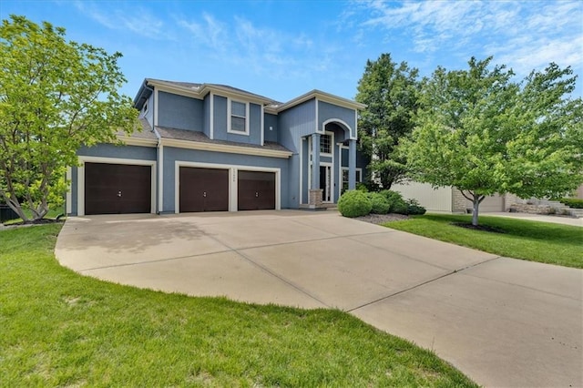 view of front of property with a front lawn and a garage