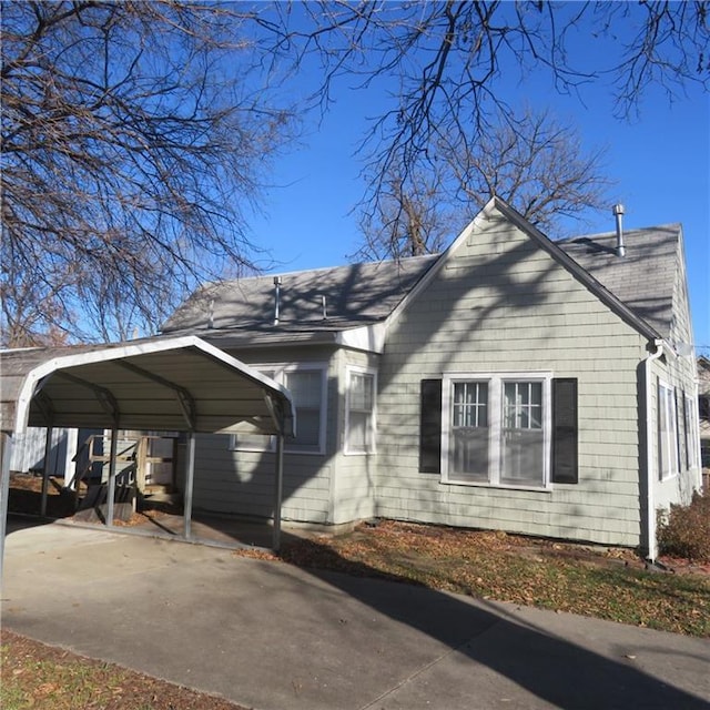 view of side of home with a carport