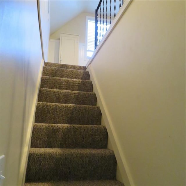 stairway with vaulted ceiling