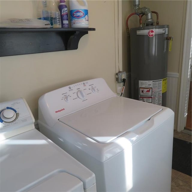 laundry area with tile patterned floors, separate washer and dryer, and water heater