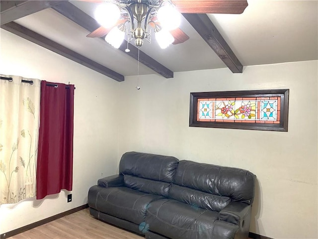 living room with beamed ceiling, light hardwood / wood-style floors, and ceiling fan