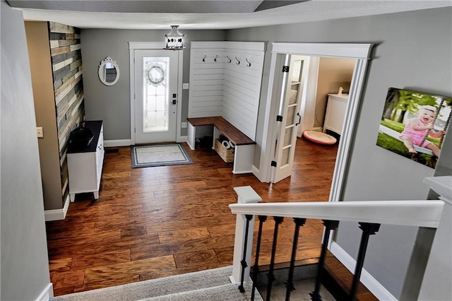 entryway with dark hardwood / wood-style floors and a chandelier