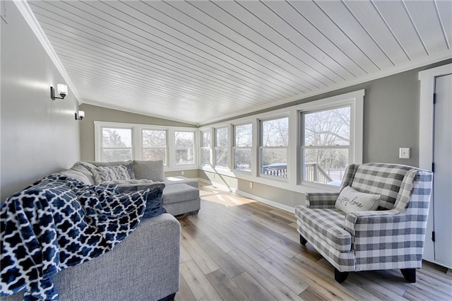 sunroom featuring wood ceiling, a healthy amount of sunlight, and vaulted ceiling