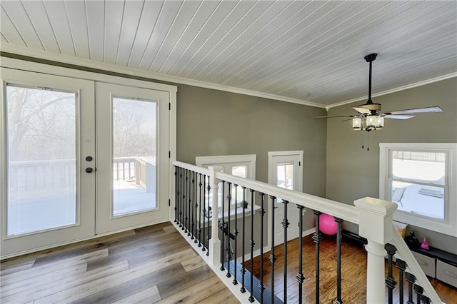 hall featuring french doors, plenty of natural light, and light hardwood / wood-style floors