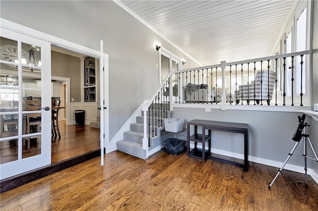 stairs featuring ornamental molding and hardwood / wood-style floors