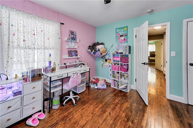 home office with a healthy amount of sunlight and dark wood-type flooring