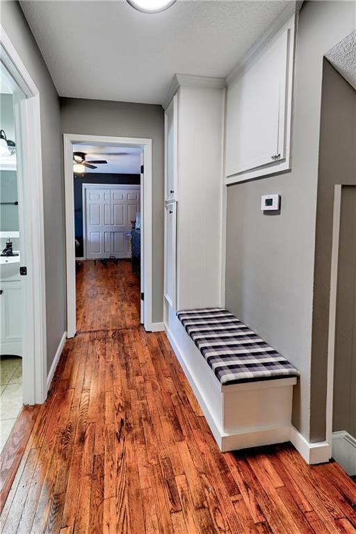 corridor with dark hardwood / wood-style flooring