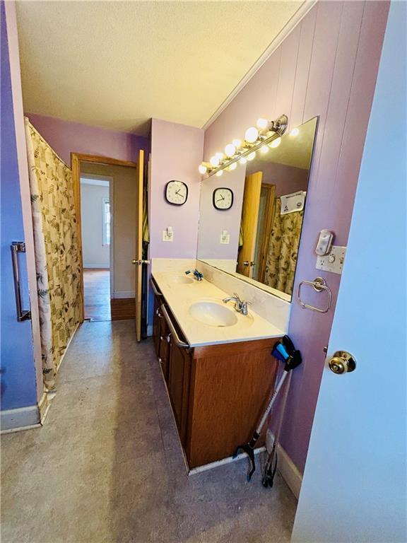 bathroom featuring vanity and ornamental molding