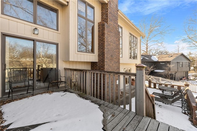 view of snow covered exterior featuring a deck