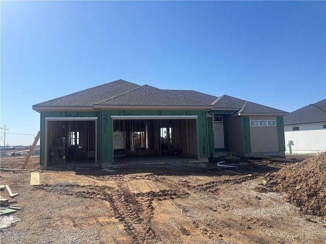 rear view of house with roof with shingles and fence