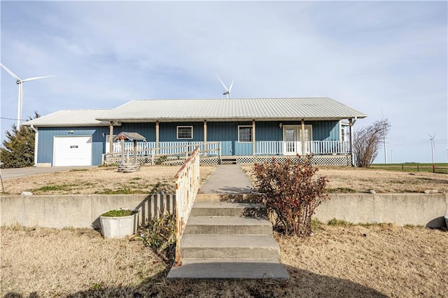 ranch-style home with a porch and a garage