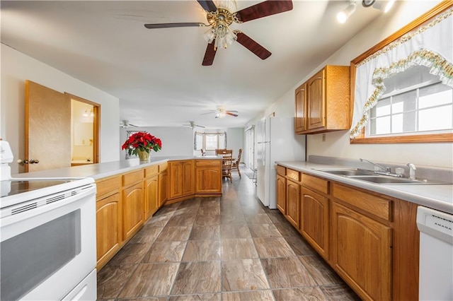 kitchen featuring kitchen peninsula, ceiling fan, sink, and white appliances