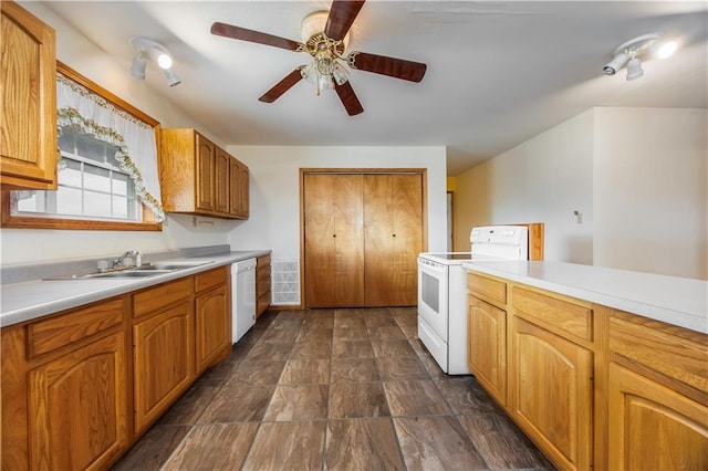 kitchen with white appliances, ceiling fan, and sink