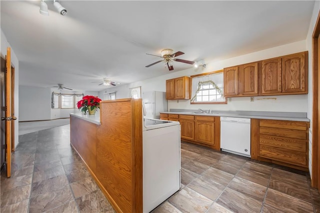 kitchen with white appliances, ceiling fan, and sink