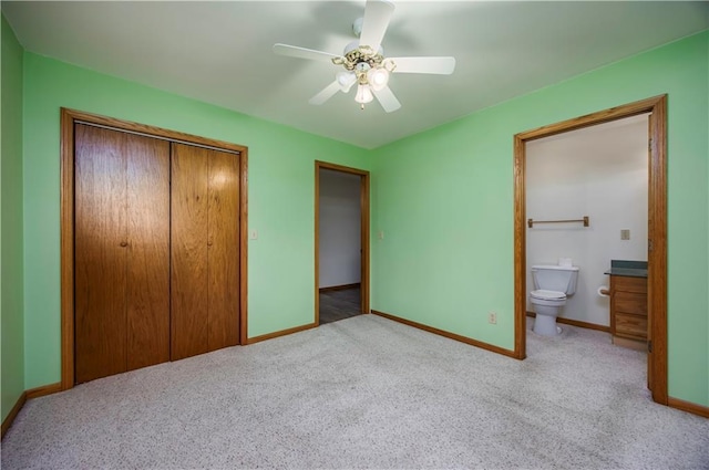 unfurnished bedroom with light carpet, ensuite bathroom, a closet, and ceiling fan