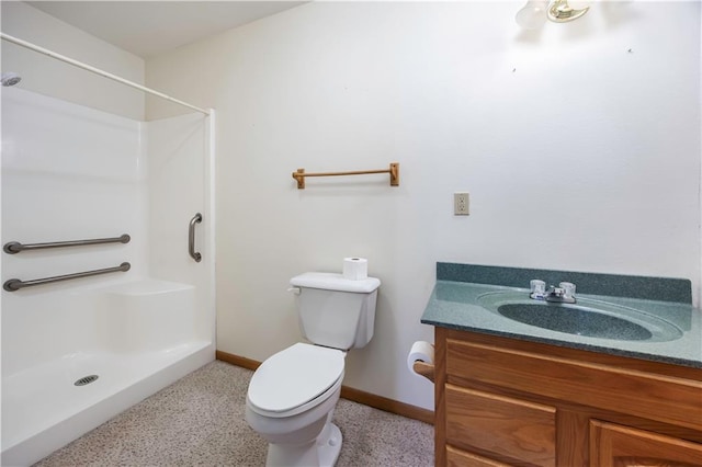 bathroom featuring vanity, toilet, and walk in shower