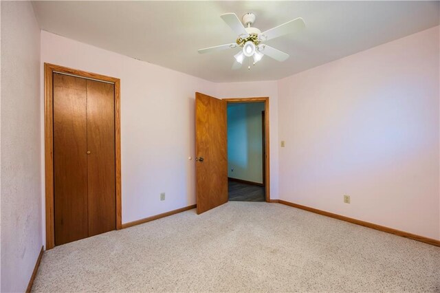 unfurnished bedroom featuring ceiling fan, a closet, and carpet floors