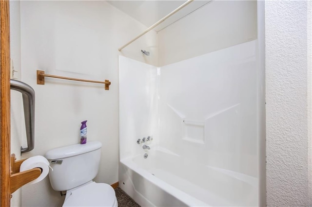 bathroom featuring toilet and tub / shower combination