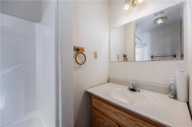 bathroom with a shower and vanity