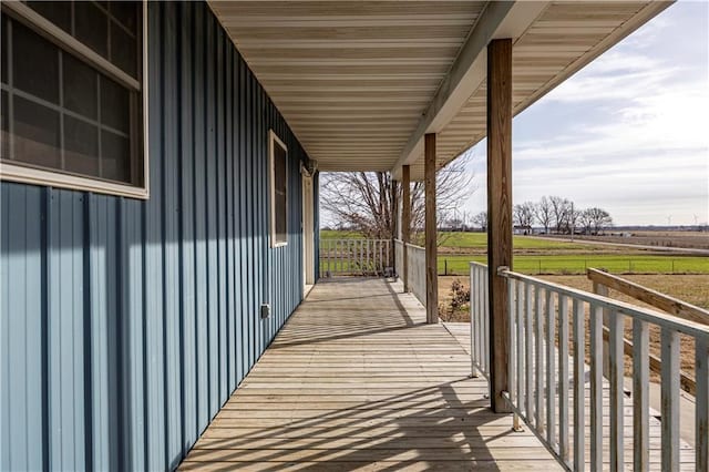 wooden deck featuring a rural view and a porch