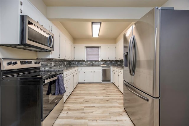 kitchen featuring light hardwood / wood-style floors, white cabinetry, appliances with stainless steel finishes, and tasteful backsplash